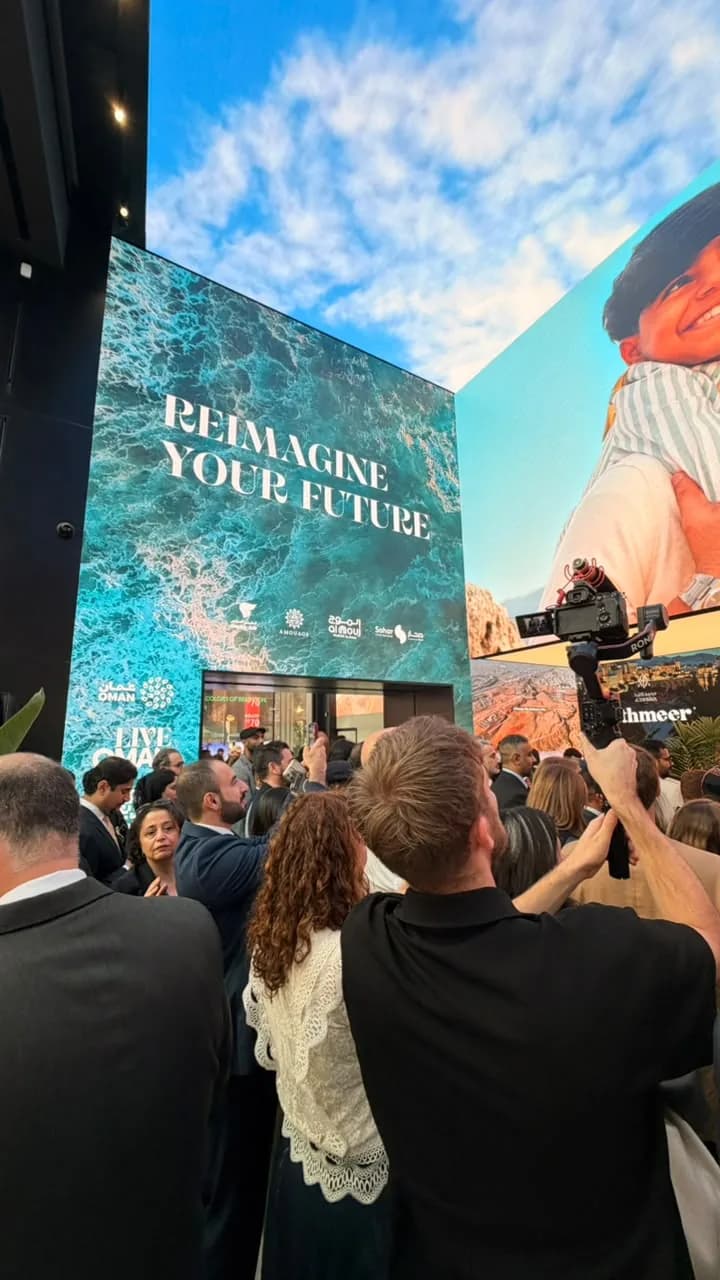 The crowd under the “Reimagine your future” screens at Live Oman, London
